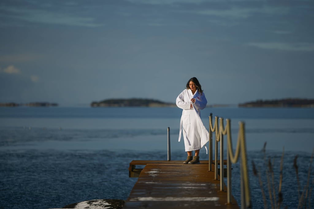 Woman after sauna going for a swim in winter
